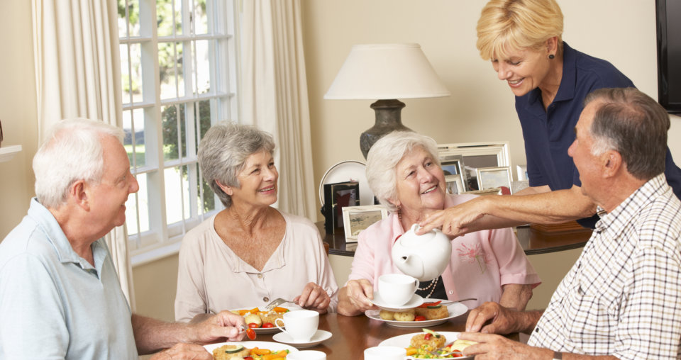 Group Of Senior Couples Enjoying Meal Together