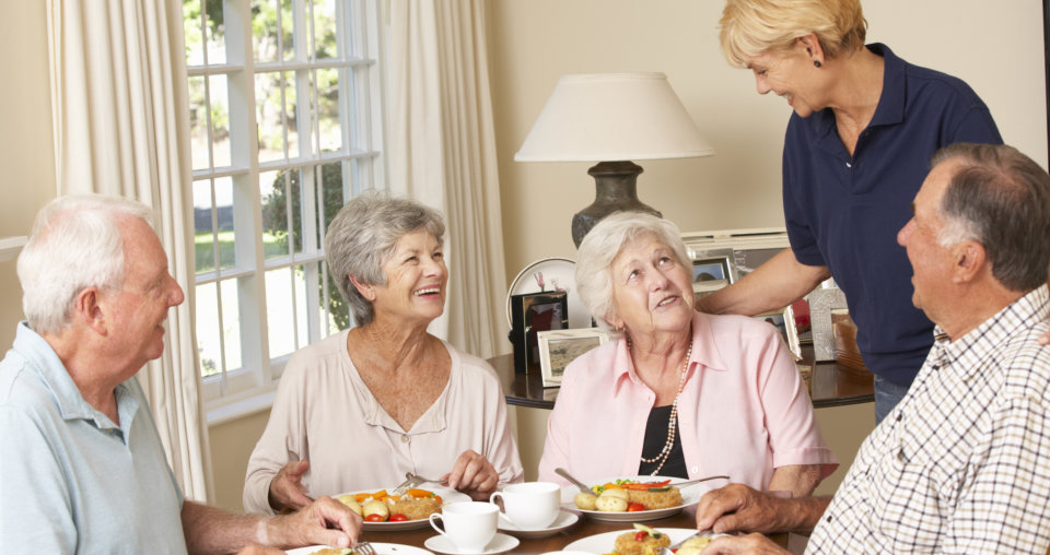 Group Of Senior Couples Enjoying Meal Together